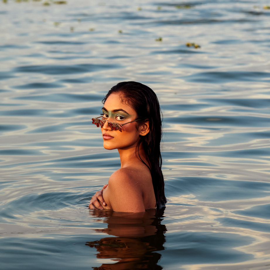 Woman with sunglasses in water